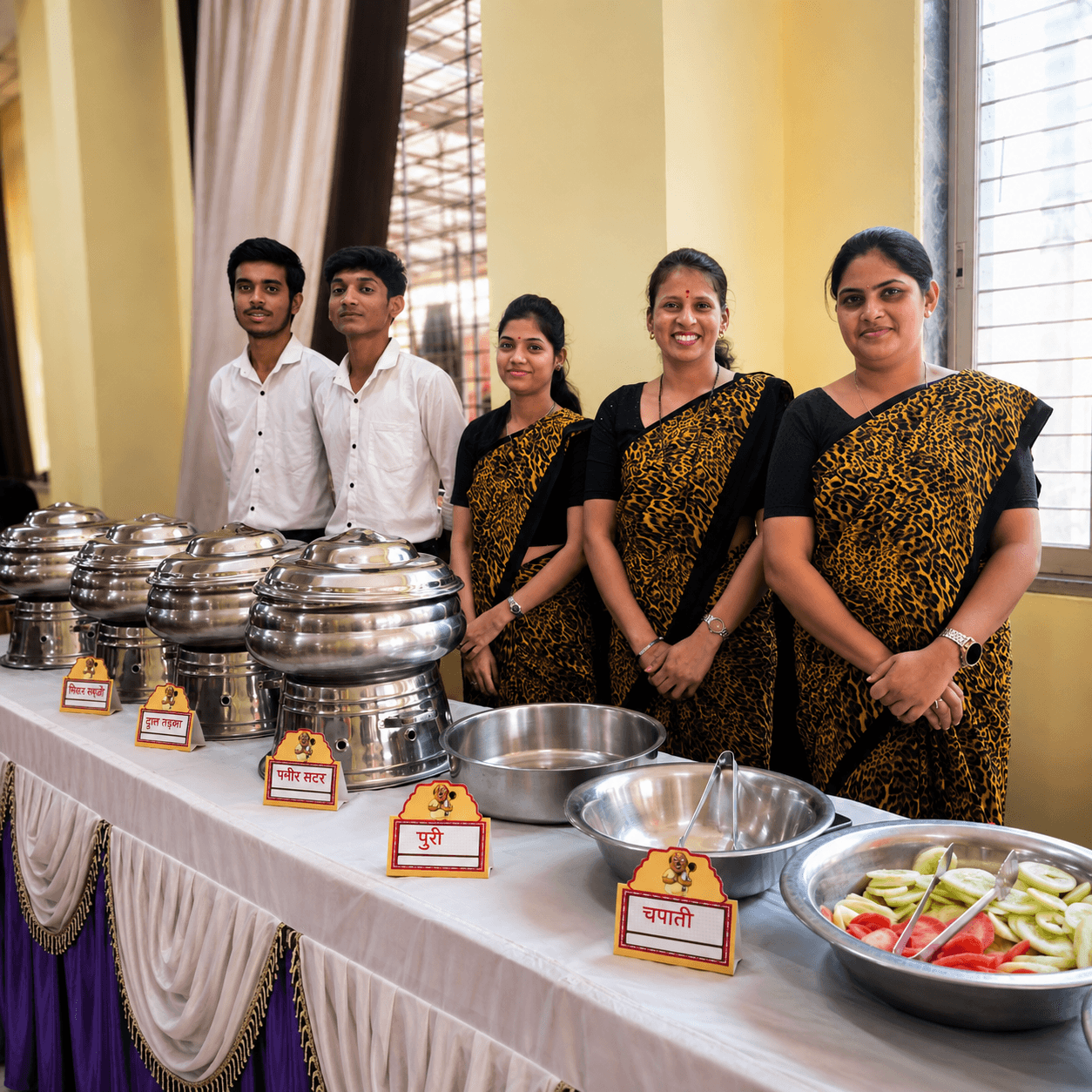 Kulcha with chole being served at a live counter, steam visible, warm event lighting